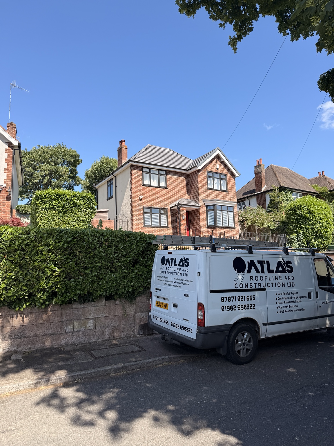 Atlas Roofline & Construction van at a completed roofing project